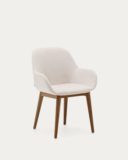 Konna chair in beige color with solid ash wood legs in a dark finish