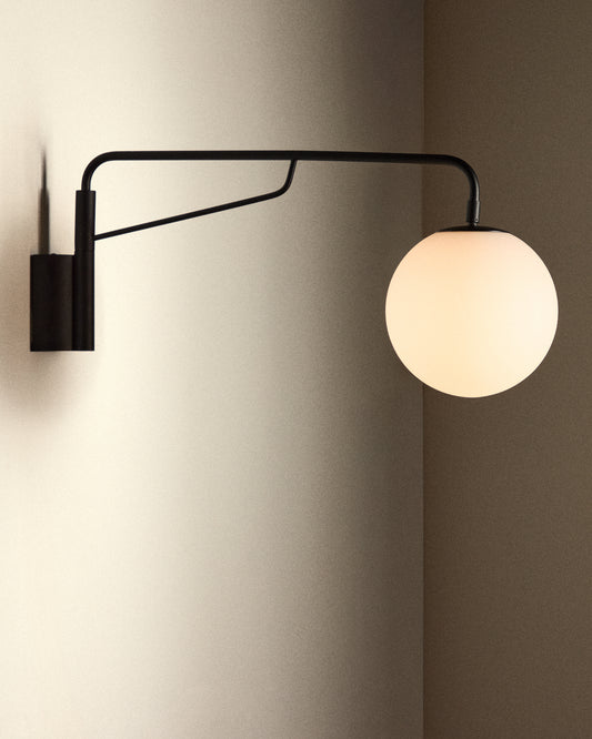 Eilo wall lamp made of black steel with a frosted glass ball